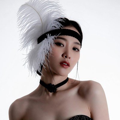 Asian woman in feathered headband
