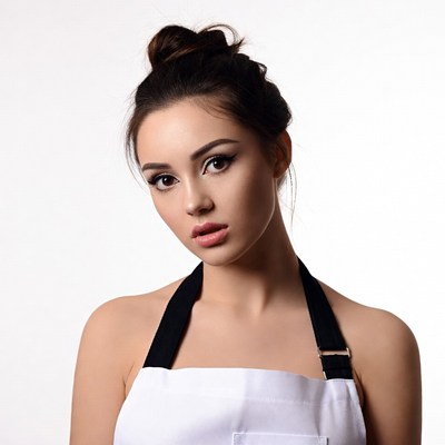 Young woman in white apron