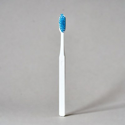 Blue Bristle Toothbrush on Gray Background
