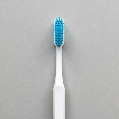 Blue bristled toothbrush on gray background