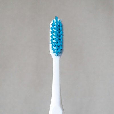 Blue Bristle Toothbrush on Gray Background