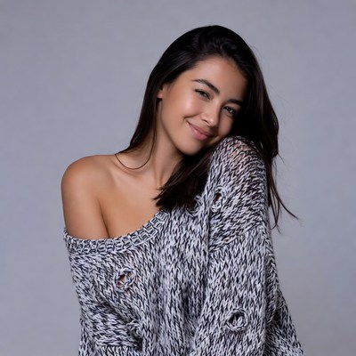 Smiling woman in off-shoulder sweater