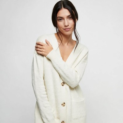 Woman in white cable knit cardigan