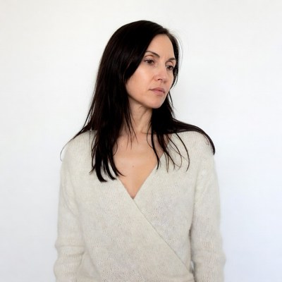 Woman in white wrap sweater