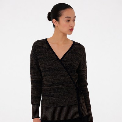 Asian woman in black wrap sweater