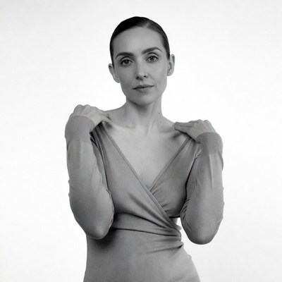 Woman pulling dress off shoulders