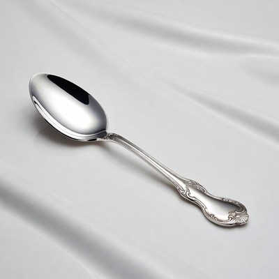 Silver spoon on white fabric
