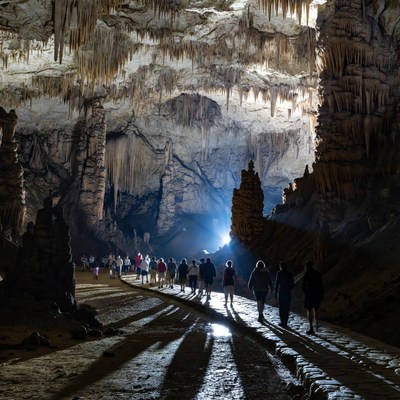 Tourists walking in stunning stalactite cave