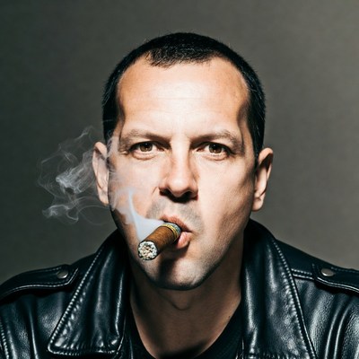 Man smoking cigar in leather jacket