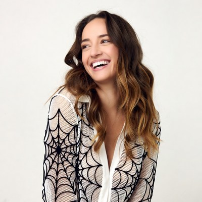 Smiling woman in sheer spiderweb shirt