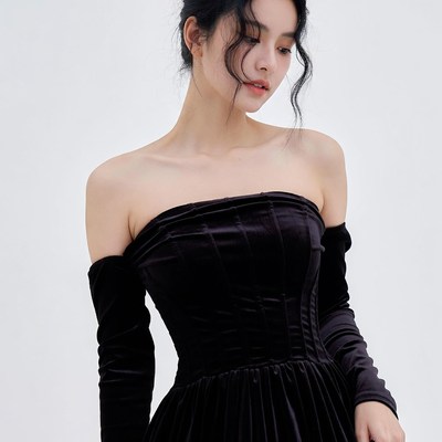 Asian woman in black velvet off-shoulder dress
