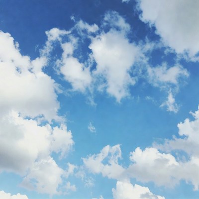 Fluffy white clouds in blue sky