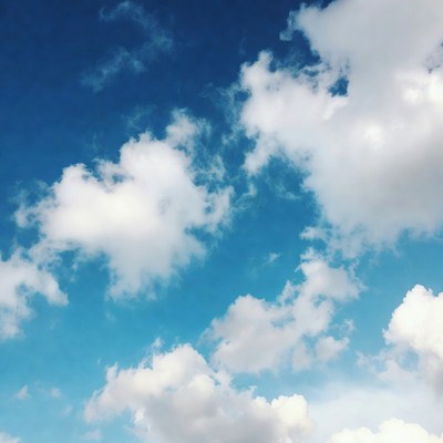 Fluffy white clouds in blue sky