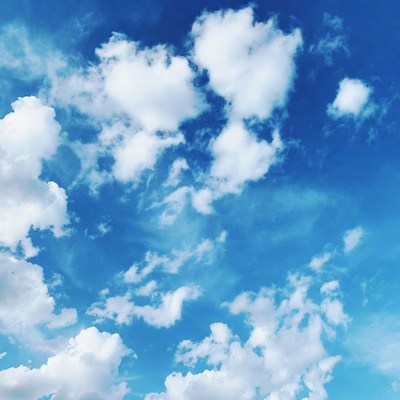 Fluffy white clouds in blue sky
