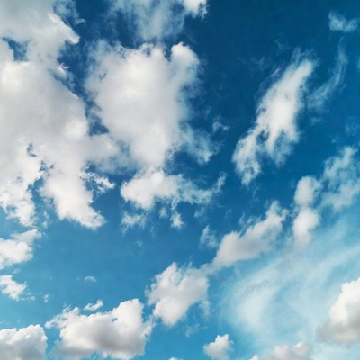 Fluffy white clouds in blue sky
