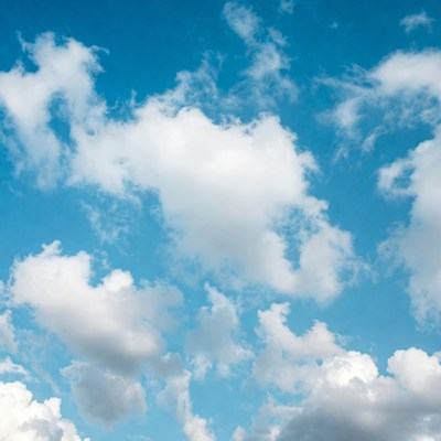 Fluffy white clouds in blue sky