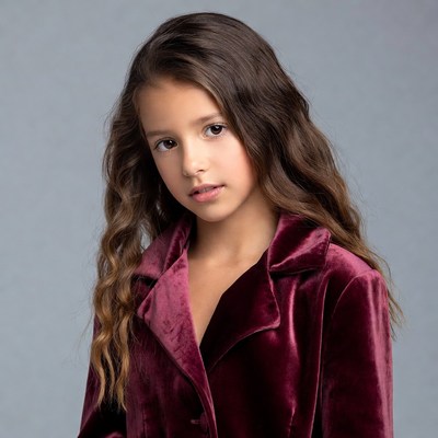 Young girl in burgundy velvet jacket