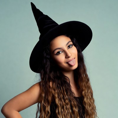 Woman in witch hat sticking tongue out