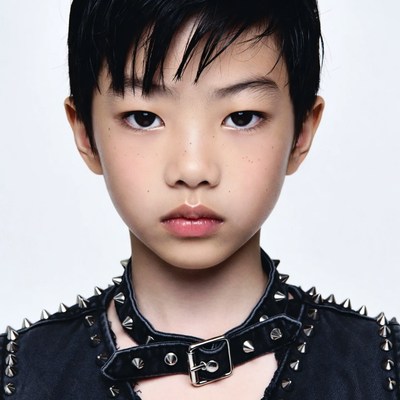 Asian boy in studded choker