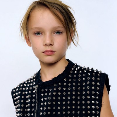 Boy in spiked black vest