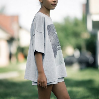 Asian girl in oversized t-shirt outdoors