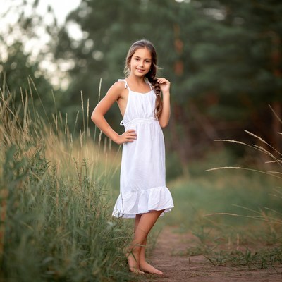Girl in white dress in grass field