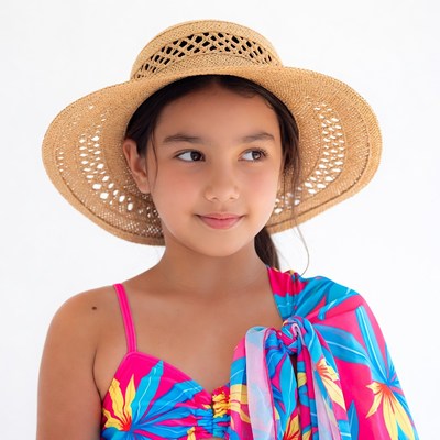 Asian girl in straw hat and floral swimsuit