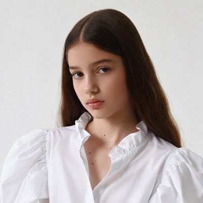 Teen girl in white ruffled blouse
