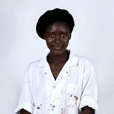 African woman in paint-splattered shirt