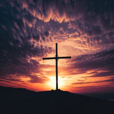 Cross on hill at sunset
