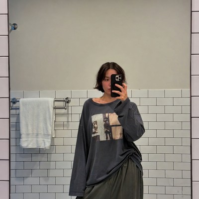 Asian woman taking bathroom selfie