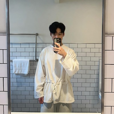 Asian man taking mirror selfie
