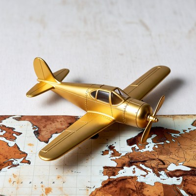 Golden Toy Airplane on World Map