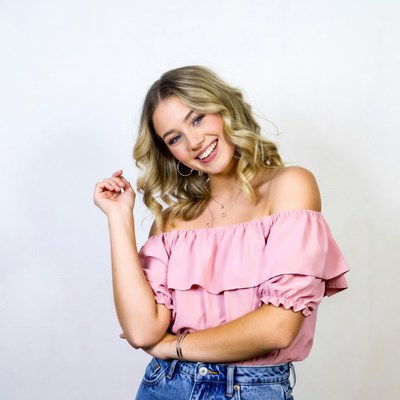Smiling woman in off-shoulder pink top