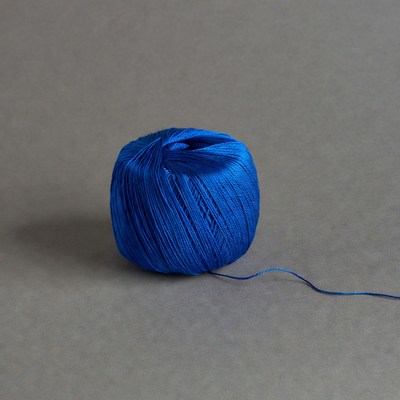 Blue yarn ball on gray background