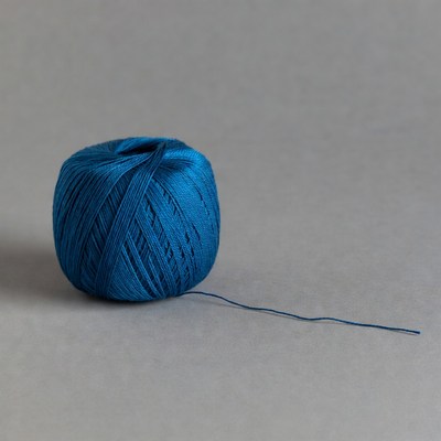 Blue yarn ball on gray background