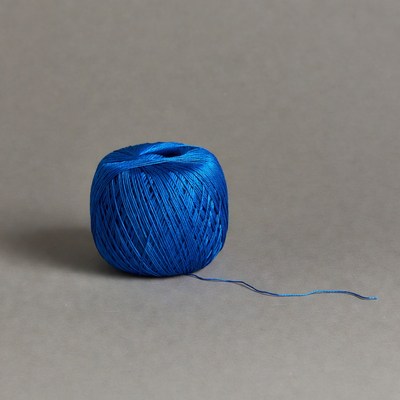Blue yarn ball on gray background