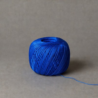 Blue yarn ball on gray background