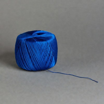 Blue yarn ball on gray background