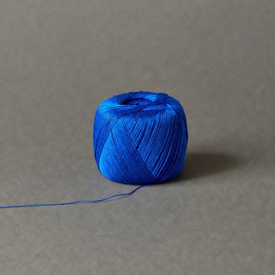 Blue yarn ball on gray background