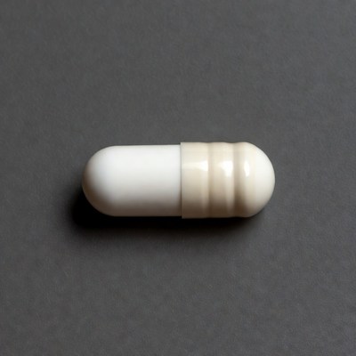 White capsule pill on gray background