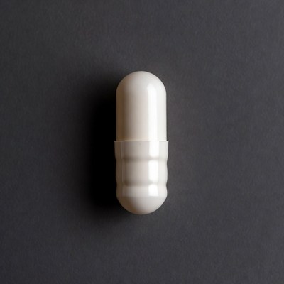 White capsule pill on gray background