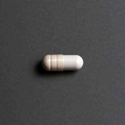 White capsule pill on gray background