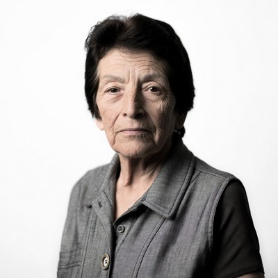 Elderly woman in gray vest