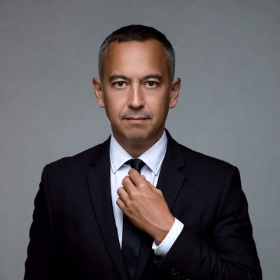 Man adjusting black tie in suit
