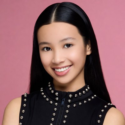 Asian girl smiling in black studded top