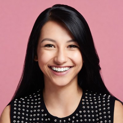 Smiling Asian woman pink background