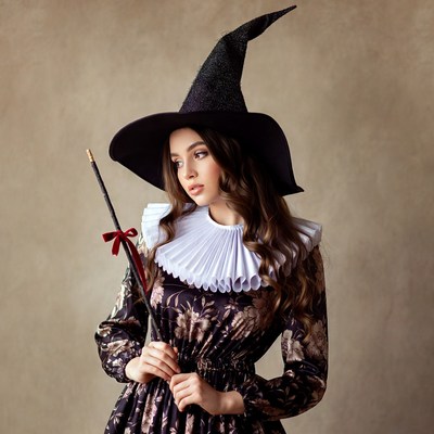 Woman in black witch hat and dress