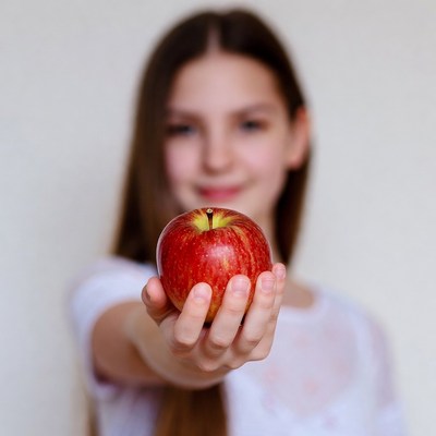 Girl holding red apple