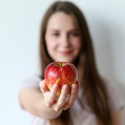 Young woman holding red apple